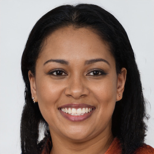 Joyful latino young-adult female with long  black hair and brown eyes