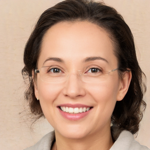 Joyful white adult female with medium  brown hair and brown eyes