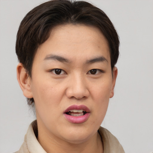 Joyful asian young-adult male with short  brown hair and brown eyes