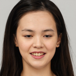 Joyful asian young-adult female with long  brown hair and brown eyes