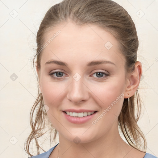 Joyful white young-adult female with medium  brown hair and blue eyes