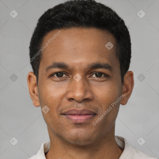 Joyful black young-adult male with short  black hair and brown eyes