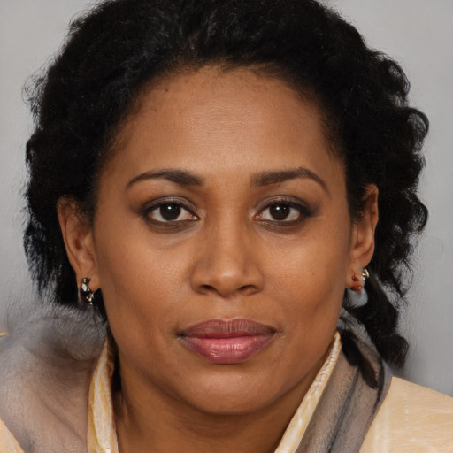 Joyful black adult female with short  brown hair and brown eyes