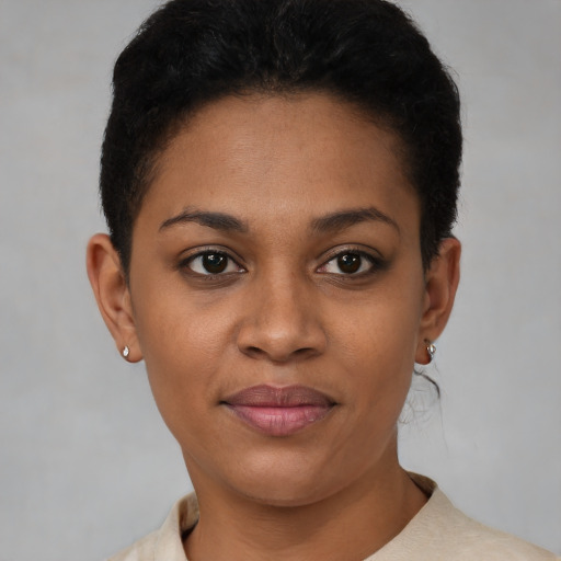 Joyful black young-adult female with short  brown hair and brown eyes