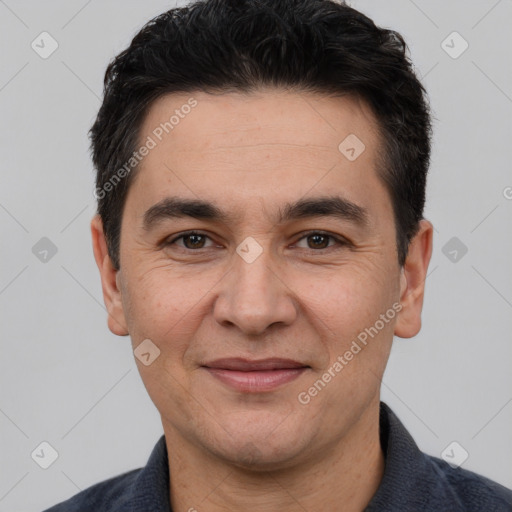 Joyful white adult male with short  black hair and brown eyes