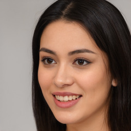 Joyful asian young-adult female with long  brown hair and brown eyes