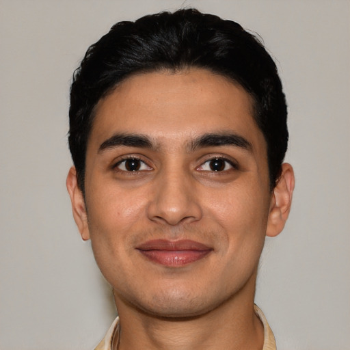 Joyful latino young-adult male with short  black hair and brown eyes