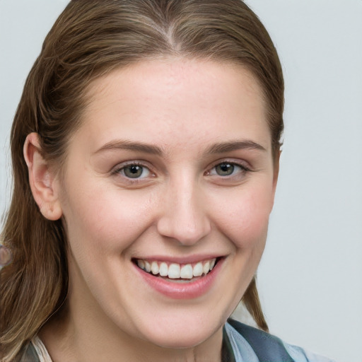 Joyful white young-adult female with long  brown hair and blue eyes