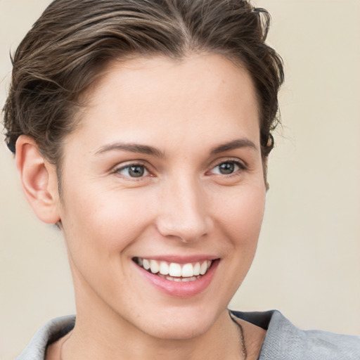 Joyful white young-adult female with short  brown hair and brown eyes