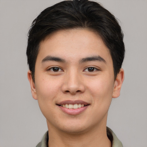 Joyful asian young-adult male with short  brown hair and brown eyes