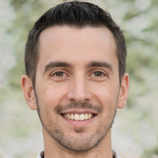 Joyful white young-adult male with short  brown hair and brown eyes