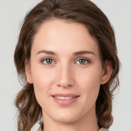 Joyful white young-adult female with medium  brown hair and green eyes