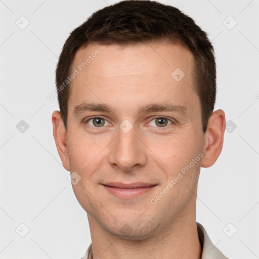 Joyful white young-adult male with short  brown hair and grey eyes