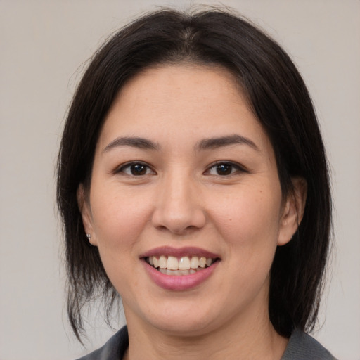 Joyful asian young-adult female with medium  brown hair and brown eyes