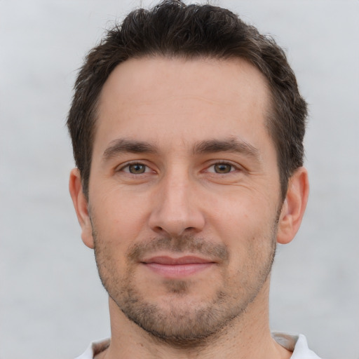 Joyful white young-adult male with short  brown hair and brown eyes