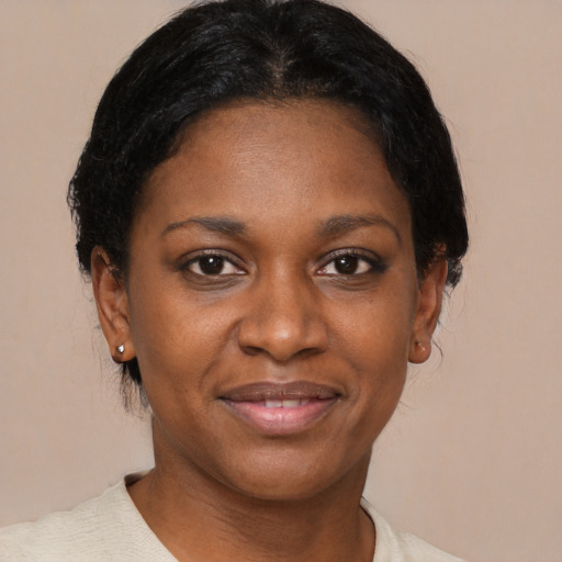 Joyful black young-adult female with medium  brown hair and brown eyes