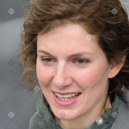 Joyful white adult female with medium  brown hair and blue eyes