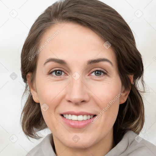 Joyful white adult female with medium  brown hair and grey eyes