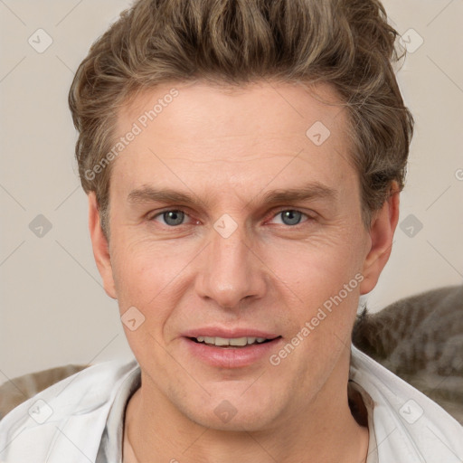 Joyful white adult male with short  brown hair and grey eyes