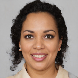 Joyful latino young-adult female with medium  brown hair and brown eyes