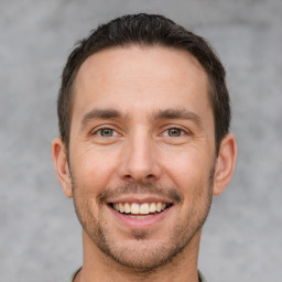 Joyful white young-adult male with short  brown hair and brown eyes