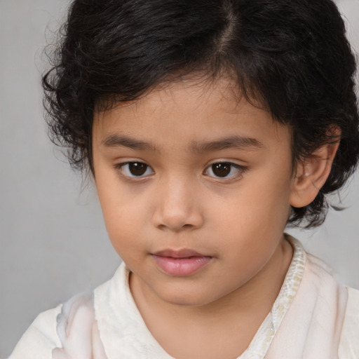 Joyful white child female with medium  brown hair and brown eyes