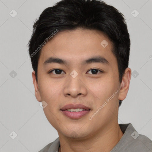 Joyful asian young-adult male with short  black hair and brown eyes