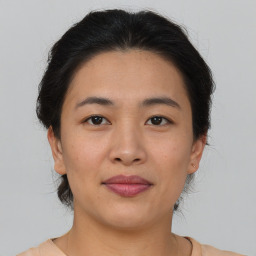 Joyful asian young-adult female with short  brown hair and brown eyes