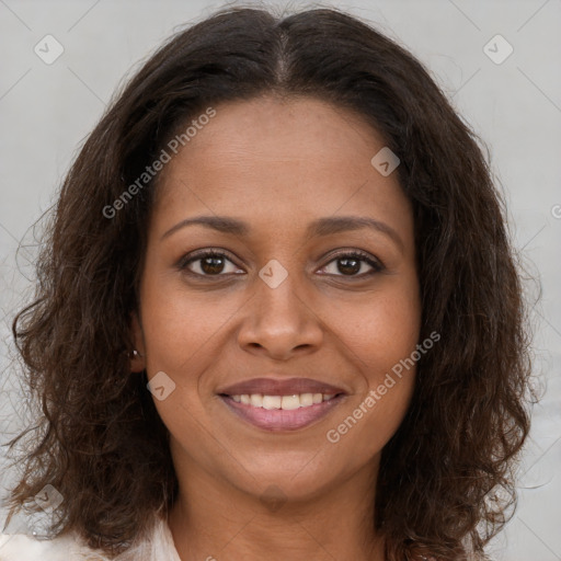 Joyful black young-adult female with long  brown hair and brown eyes