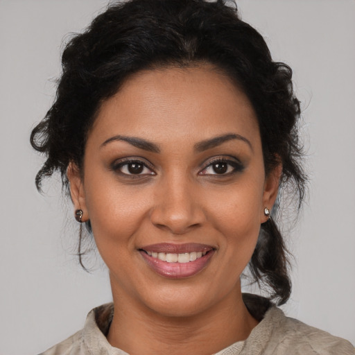 Joyful black young-adult female with medium  brown hair and brown eyes