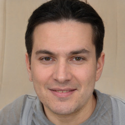 Joyful white adult male with short  brown hair and brown eyes