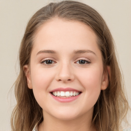 Joyful white young-adult female with long  brown hair and grey eyes