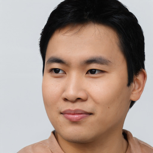 Joyful asian young-adult male with short  black hair and brown eyes