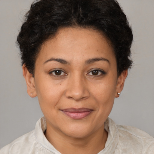 Joyful latino young-adult female with short  brown hair and brown eyes