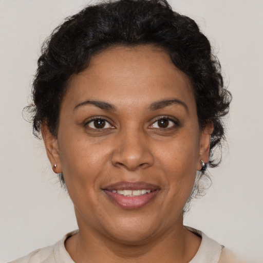 Joyful black adult female with short  brown hair and brown eyes