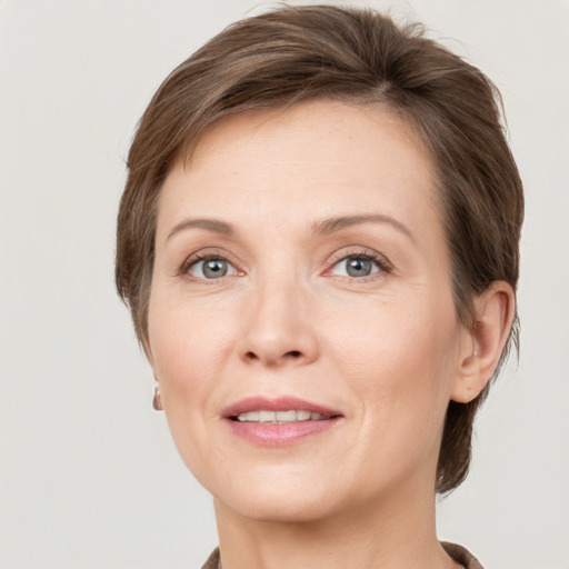 Joyful white adult female with short  brown hair and grey eyes