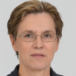 Neutral white middle-aged female with short  brown hair and blue eyes