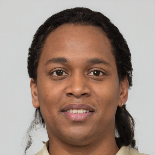 Joyful black young-adult male with short  black hair and brown eyes