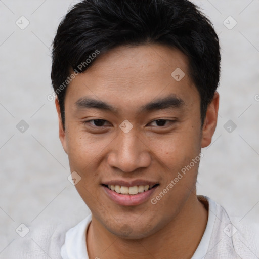 Joyful asian young-adult male with short  black hair and brown eyes