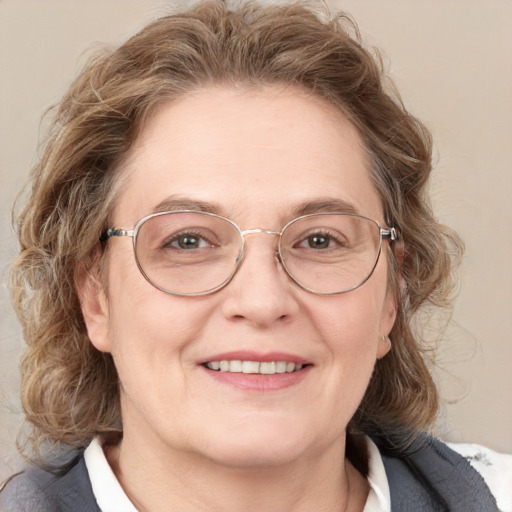 Joyful white adult female with medium  brown hair and blue eyes