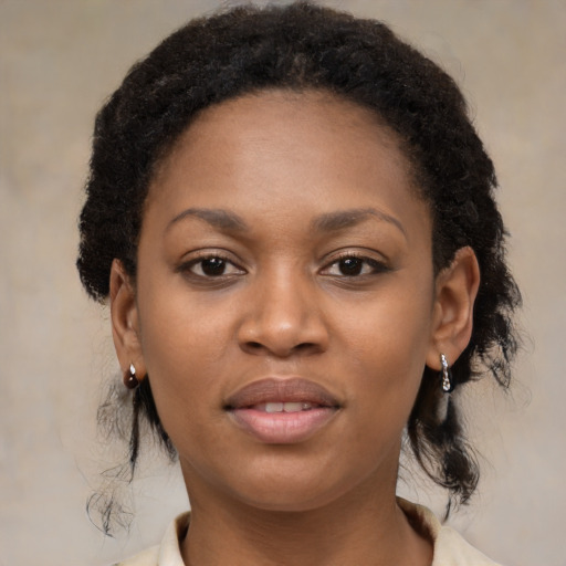 Joyful black young-adult female with medium  black hair and brown eyes