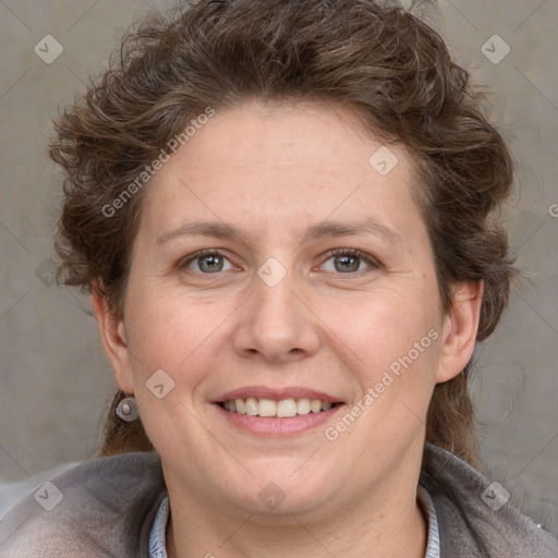 Joyful white adult female with short  brown hair and grey eyes