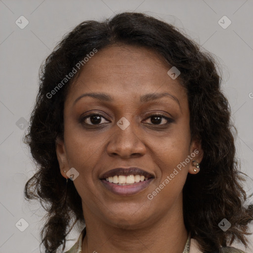 Joyful black adult female with long  brown hair and brown eyes