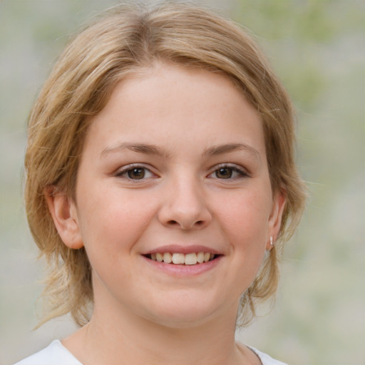 Joyful white child female with medium  brown hair and brown eyes