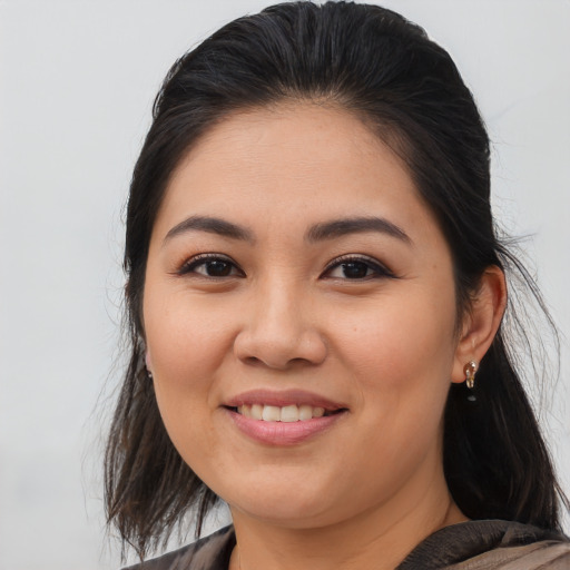 Joyful latino young-adult female with medium  brown hair and brown eyes