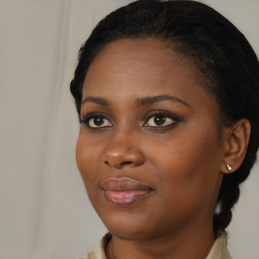 Joyful black young-adult female with medium  black hair and brown eyes