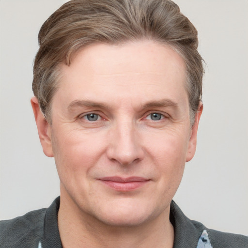 Joyful white adult male with short  brown hair and grey eyes