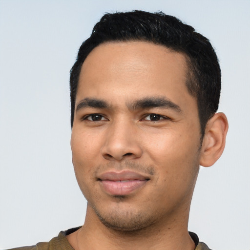 Joyful latino young-adult male with short  black hair and brown eyes