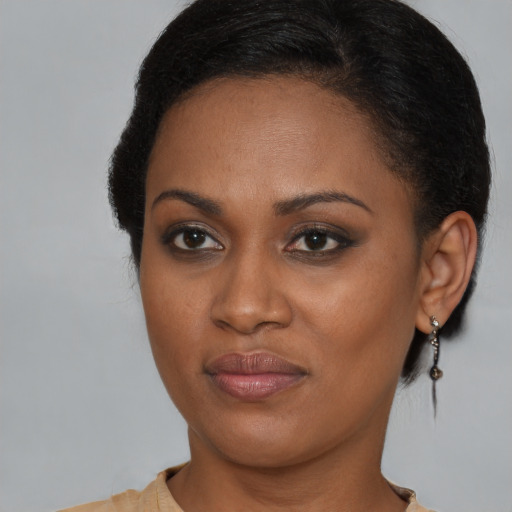 Joyful black young-adult female with short  brown hair and brown eyes