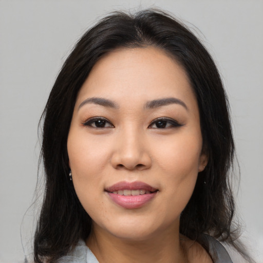 Joyful asian young-adult female with medium  black hair and brown eyes